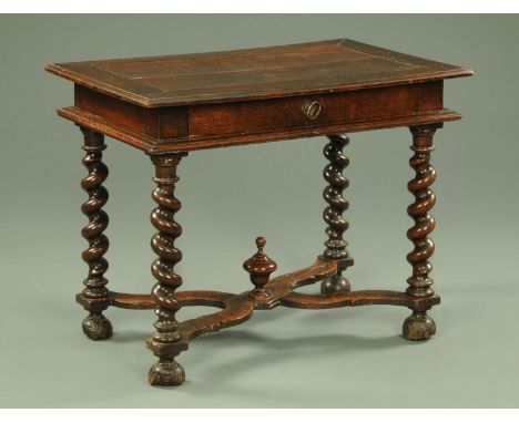 An antique oak side table, with moulded edge above a recessed frieze with single drawer and raised on barley sugar twist turn