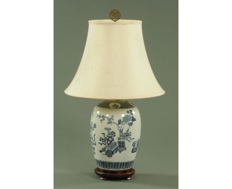 A Chinese blue and white table lamp, 20th century, decorated with precious objects beneath a peach and cell border.  Height e