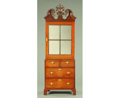 A George III mahogany cabinet and combined chest, probably Irish, with swans neck pediment above a single glazed door enclosi