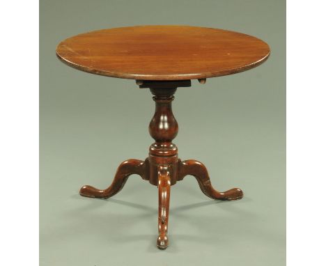 A George III mahogany tripod table, with bird cage and turned column raised on three downswept legs terminating in pad feet. 