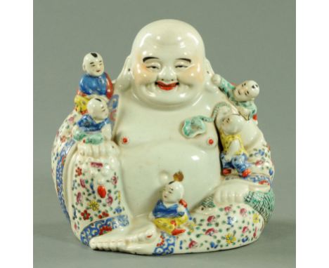 A Chinese porcelain figure of Hotei, 20th century, modelled seated with is sack of treasures with young boys clambering aroun