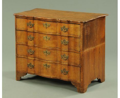 A 19th century Dutch oak chest of drawers, with serpentine front fitted with four drawers with brass handles and lock escutch