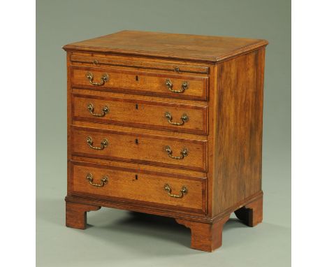 A 19th century oak and mahogany crossbanded chest of drawers, with slide above four graduated drawers with brass drop handles