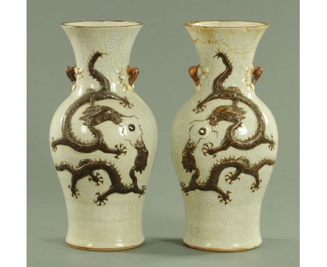 A pair of Chinese crackle ware vases, late 19th century, each decorated with a pair of relief dragons chasing a pearl and wit