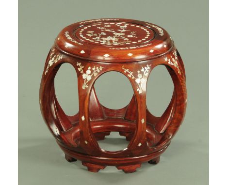 A Chinese hardwood and mother of pearl inlaid drum form vase stand, 20th century with inlaid bird and flowering peony decorat