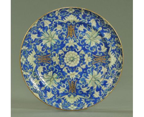 A Chinese dished plate, Tongzhi period, decorated with white and blue enamel lotus flowers with gilt double Shou and four sty