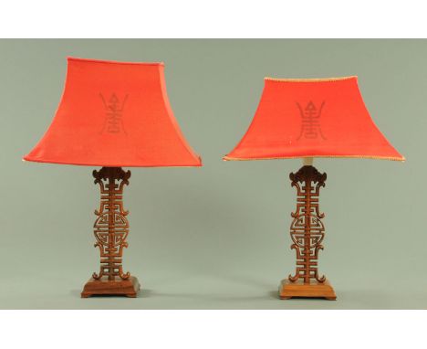 A pair of Chinese hardwood table lamps, each with rectangular shade.  Height excluding light fitting 36 cm. 