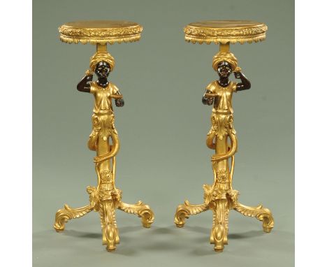 A pair of Blackamoor pedestals, each figure supporting a circular shelf and all raised on three downswept legs, height 94 cm.