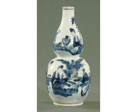 A Chinese blue and white double gourd vase, late 19th century, painted with females playing Go within a garden surrounding, f