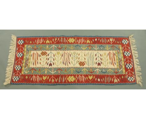 An Eastern fringed runner, with centre beige panel and fringed ends.  200 cm x 88 cm. 