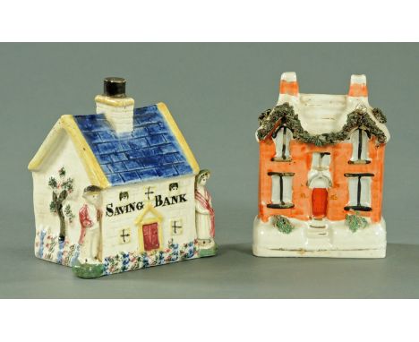 An early 19th century Staffordshire pottery cottage form money box, inscribed to the front "Savings Bank" and flanked by a ma