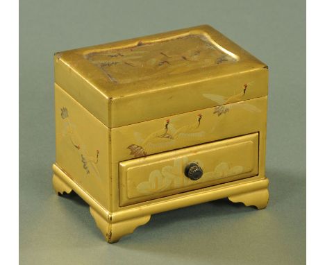 A Japanese miniature tabletop chest, Meiji - Taisho period, decorated throughout with Manchurian cranes against a gilt ground