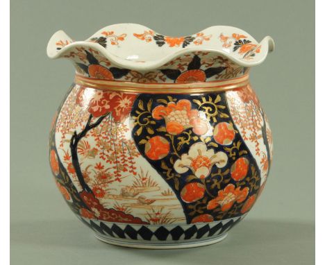 A Japanese Imari jardiniere, late Meiji period, having a wavy rim above panels of wisteria, ducks and scrolling lotus.  Diame