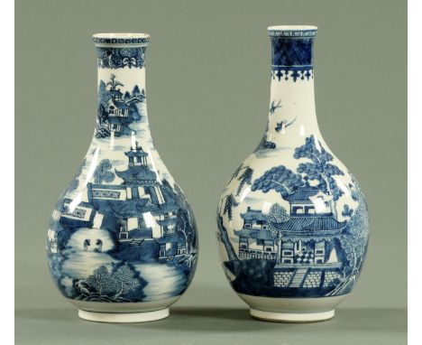 A near pair of Chinese blue and white bottle vases, 19th century, decorated with a pagoda and river landscape, 26 cm high (se