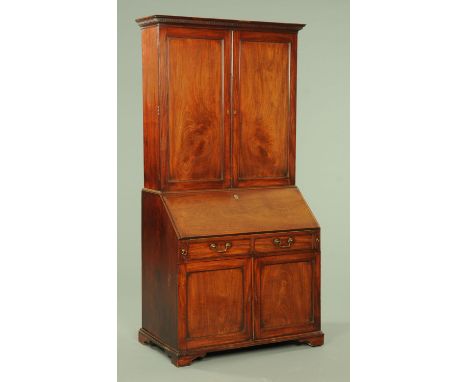 A good George III mahogany bureau bookcase, with moulded dentil cornice above a pair of well figured doors opening to a serie