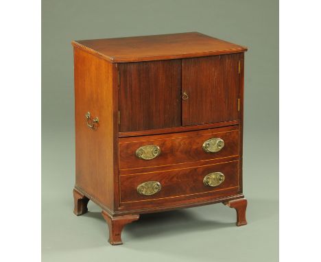 A Georgian mahogany bedside cabinet, with pair of doors above one deep drawer with brass drop handles with oval backplates an