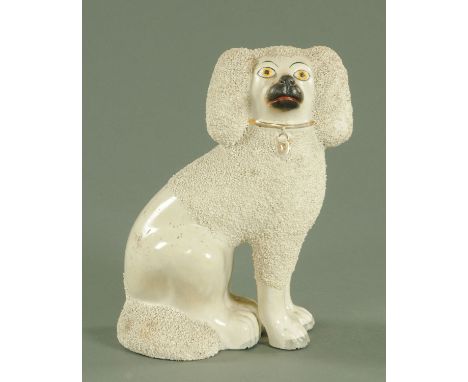 A 19th century Staffordshire poodle, with painted face and gilt collar with padlock and with separate moulded front legs, ini