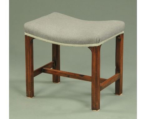 A George III mahogany stool, with bowed seat and raised on moulded legs united by stretchers.  Width 51 cm, depth 38 cm, heig