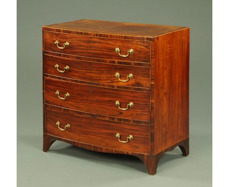 A George III mahogany bowfronted chest of drawers, with rosewood banded edge, four long graduated drawers with brass drop han