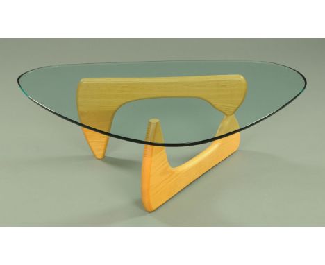 After Isamu Noguchi, a contemporary glass topped coffee table, the table base comprising of two shaped sections of natural ha