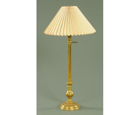 A late 19th century brass adjustable table lamp, with plain column with knopped base on circular foot.  Height excluding shad