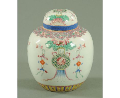 A Chinese Famille Rose ginger jar and cover, 19th century, the shoulder decorated with Ruyi heads and peonies against a pink 