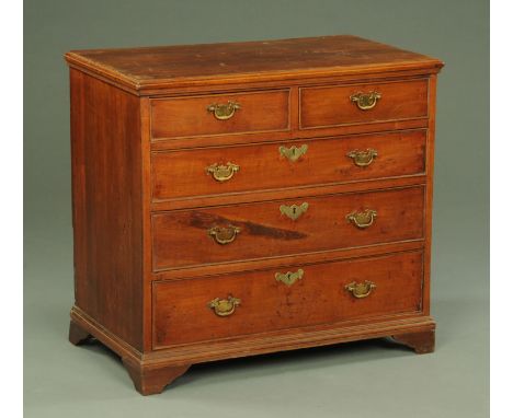 A Georgian mahogany chest of drawers, with two short and three long drawers with brass drop handles and lock escutcheons and 