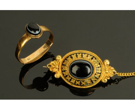 A Victorian 22 ct gold ring, size M, and a gold coloured metal brooch with safety chain.  CONDITION REPORT: The shank whilst 