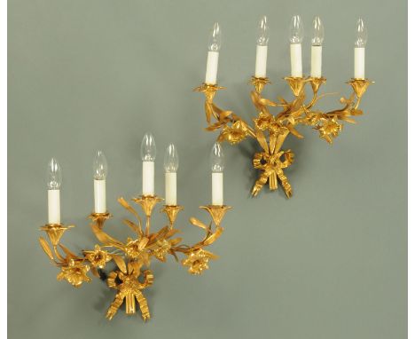 A pair of gilt metal five branch wall light sconces, foliate and with ribbon and bow to the base.  Height excluding light fit