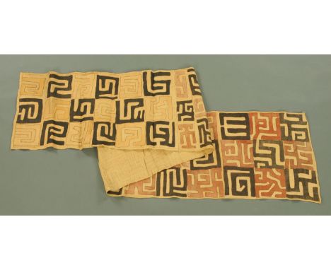 An African Cuba cloth runner, 20th century, the geometric patterns on a raffia ground. Length 336 cm, width 53 cm.