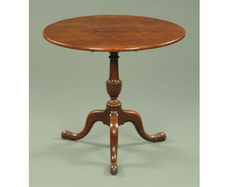 A George III oak tripod table, with snap action and vase turned column with three downswept legs terminating in pad feet.  Di