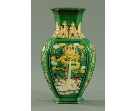 A Chinese biscuit porcelain hexagonal vase, 19th century, the shoulder decorated with stiff leaves, the body with a relief mo