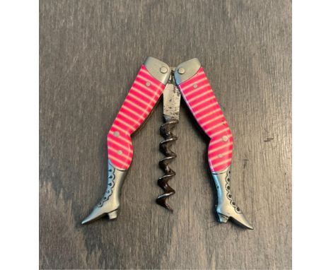 A late 19th / early 20th century German novelty corkscrew in the form of a pair of ladies legs, celluloid bright pink and pea
