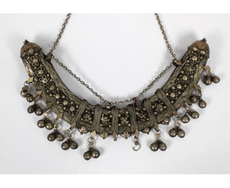 An Ethiopian silver telsum neck amulet, the curved body 27cm. wide.