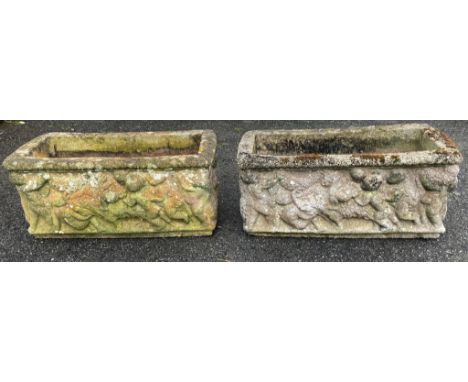 A pair of composite stone rectangular trough planters, decorated with putti / cherubs, 54cm. long. (2)