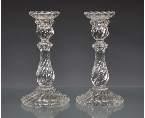 A pair of Baccarat 'Bambous' glass candlesticks, each wrythen lobe moulded, the drip pan over a sconce, baluster column and s