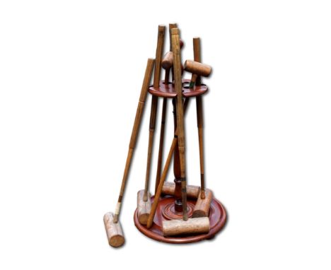 A Victorian and later croquet set and mahogany stand, to include various croquet mallets for adults and children, cast iron h