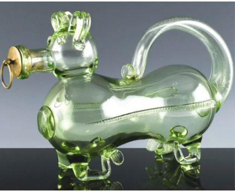A  rare late 19th or early 20th century novelty green glass whiskey decanter in the form of a dog, the handle formed from the