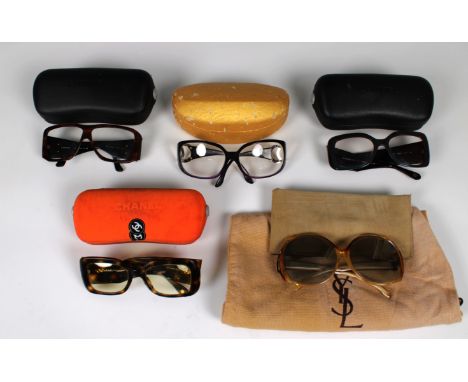 Four pairs of vintage prescription Chanel glasses, one pair tinted, together with a pair of Yves Saint Laurent sun glasses. (