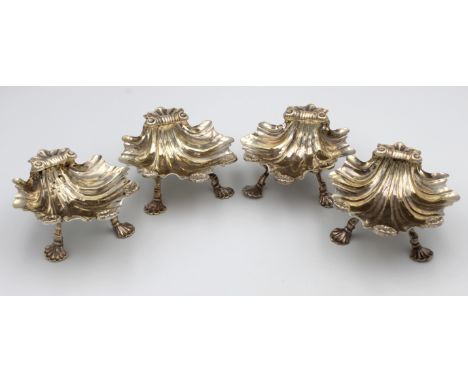 A matched set of  three Georgian silver scallop shell butter dishes, hallmarks indistinct, each raised on three elongated she