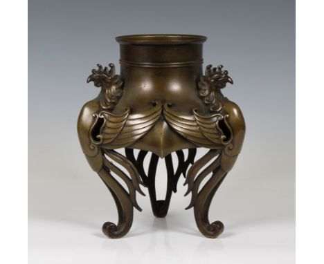 A Chinese bronze censer/stand, of open baluster form supported by three phoenix figures with spread wings and feathers traili