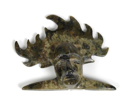 An Inuit serpentine stone carving by Turaq Ragee (b.1963), Cape Dorset, Spirit Mask, signed to base, 9cm. high.