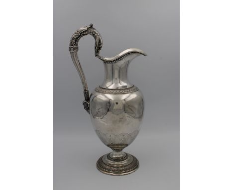 A French Louis XVIII to Louis Philippe era sterling silver wine ewer, of typical form with stylised foliate bands, the handle