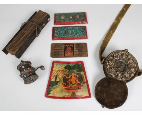 A Tibetan Buddhist white metal prayer wheel set with turquoise and coral, prayer scroll inside, 6cm. diameter, 11cm. high, to