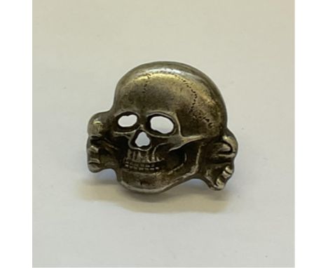 A Second War Waffen SS Totenkopf deaths head cap skull badge with markings, indistinct possibly R.Z.M.