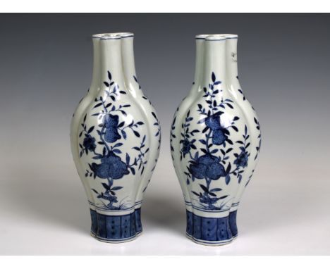 A pair of Chinese blue and white lobed vases, the triform body painted with fruiting branches, with later Qianlong reign mark