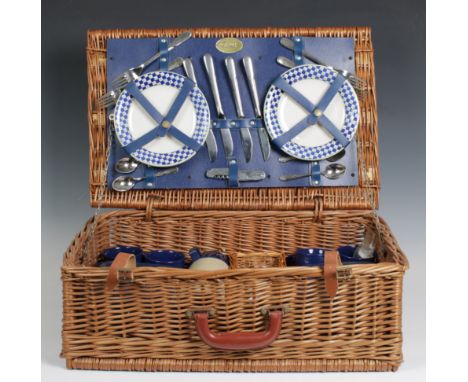 A vintage Harrods wicker picnic hamper with full unused contents and travel rug.,
