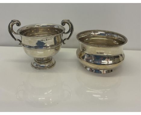 A silver basin, Atkin Brothers, Sheffield, 1912, of waisted circular form, central foot, gadroon rim, 8cm. high, together wit