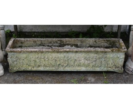 A composite stone rectangular trough planter, depicting frolicking cherubs, 100cm. long.