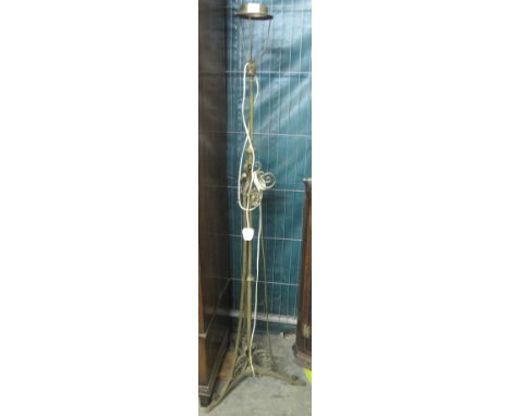 Wrought iron telescopic standard lamp with applied scroll decoration on triform base, now converted to electricity.(B.P. 24% 